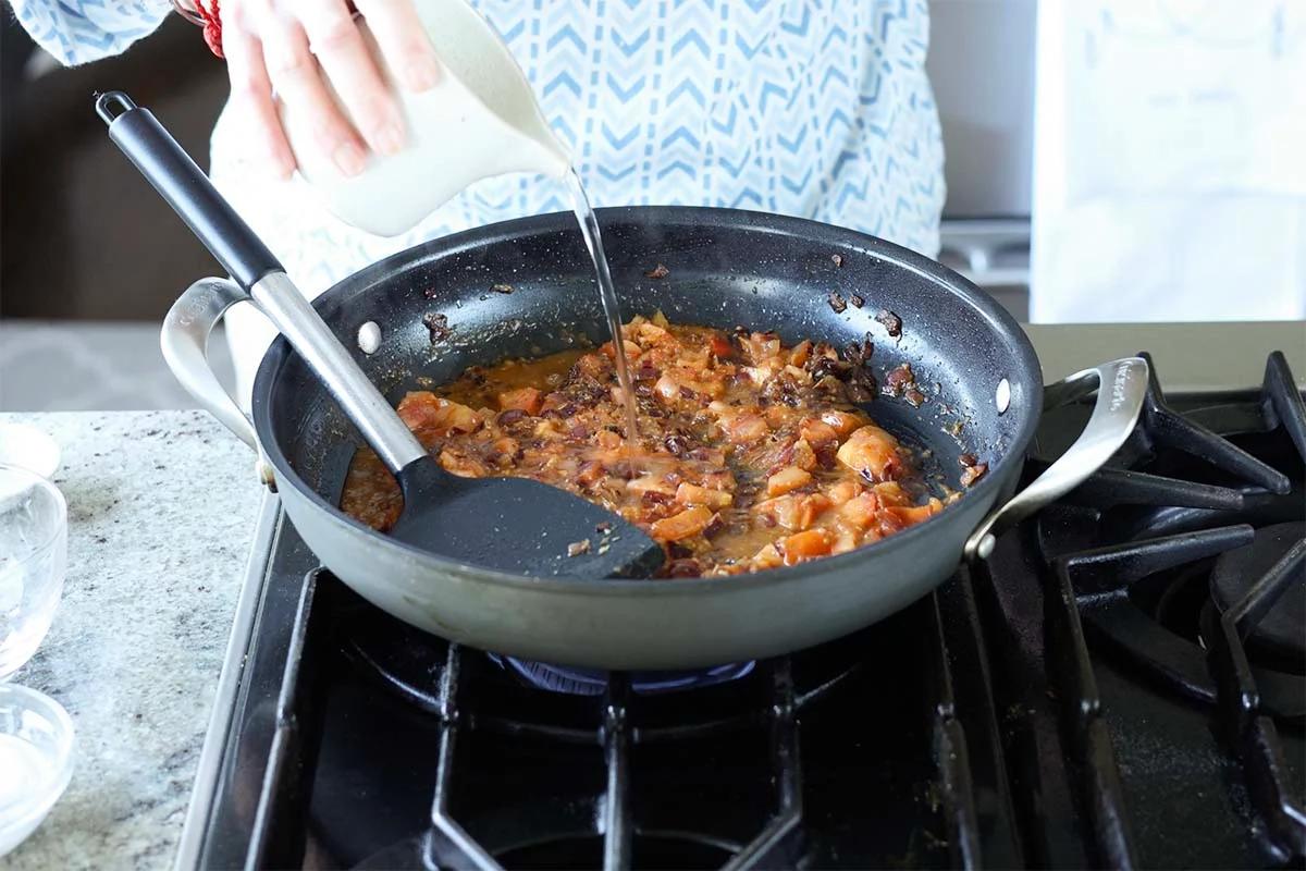 adding water to the pan