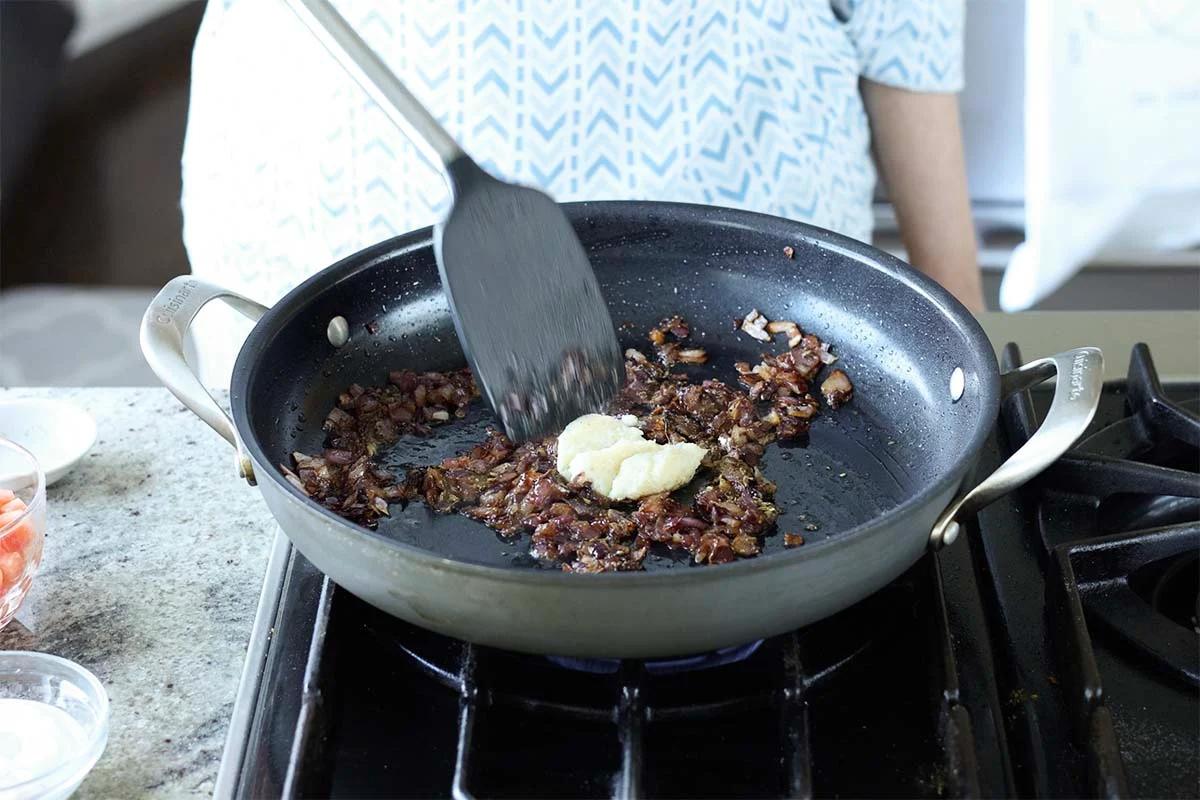 adding ginger garlic paste to the pan