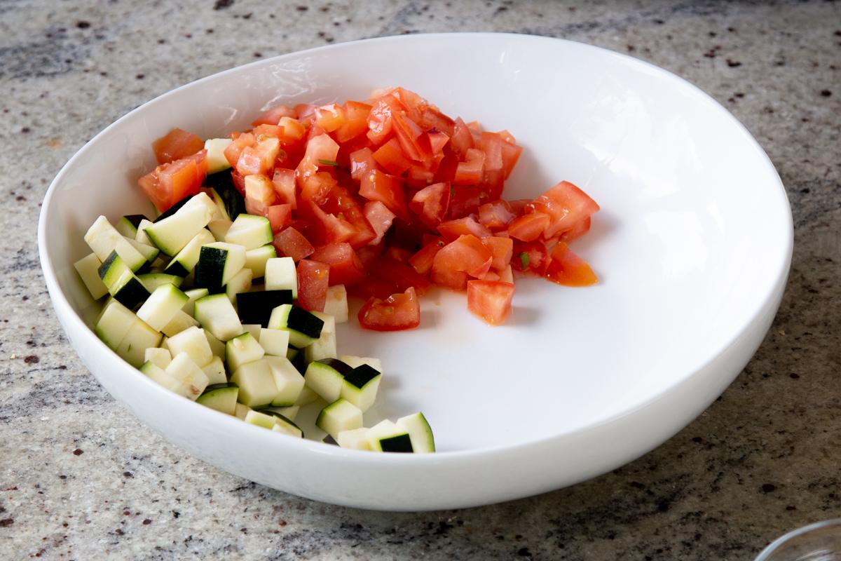 adding tomato to the salad bowl