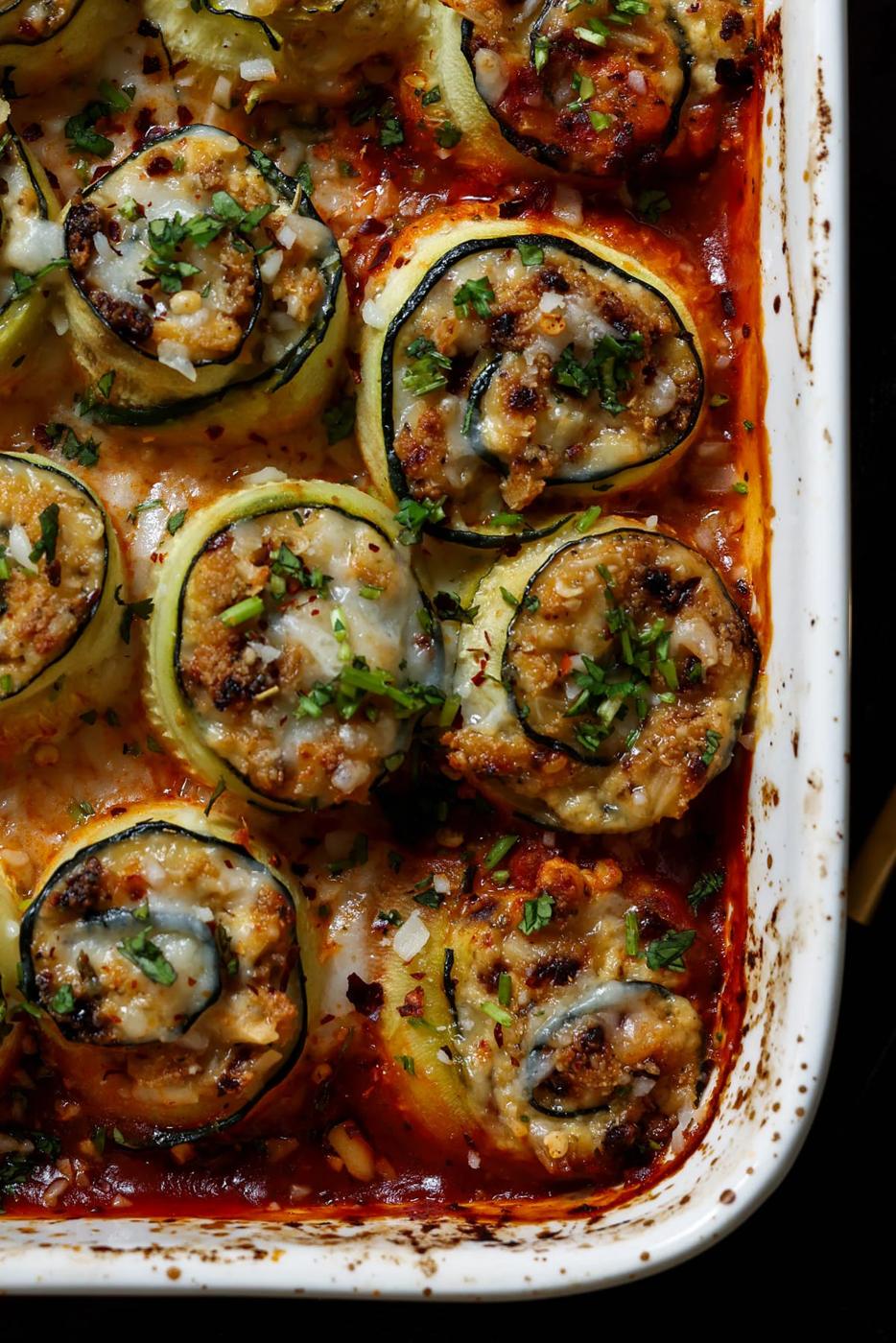 close-up of zucchini rolls in the baking dish after baking