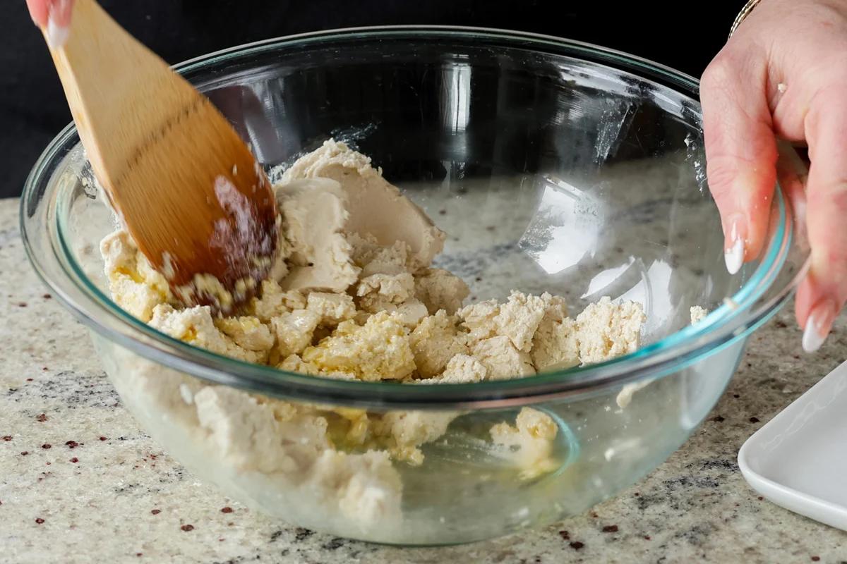 mixing the tofu and cream cheese together in a bowl