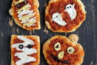 Spooky Vegan Halloween Pizzas Ghost Pumpkin Mummy Shapes Creamy Coconut Milk Cheese Blend Flavorful Sundried Tomato Marinara on a Hearty Sesame Barley Crust