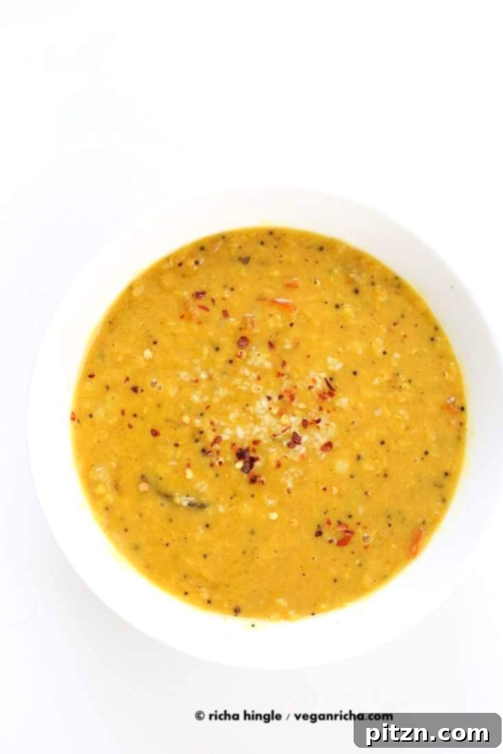 Close-up of creamy Sri Lankan Red Lentil Curry, showcasing the rich texture and vibrant color. Spiced with fenugreek seeds, cinnamon, black peppercorns, and coconut milk. Easy Vegan Gluten-free Soy-free Recipe. No garlic recipe. | VeganRicha.com #vegan #easy #glutenfree #soyfree #lentils #dal #recipe