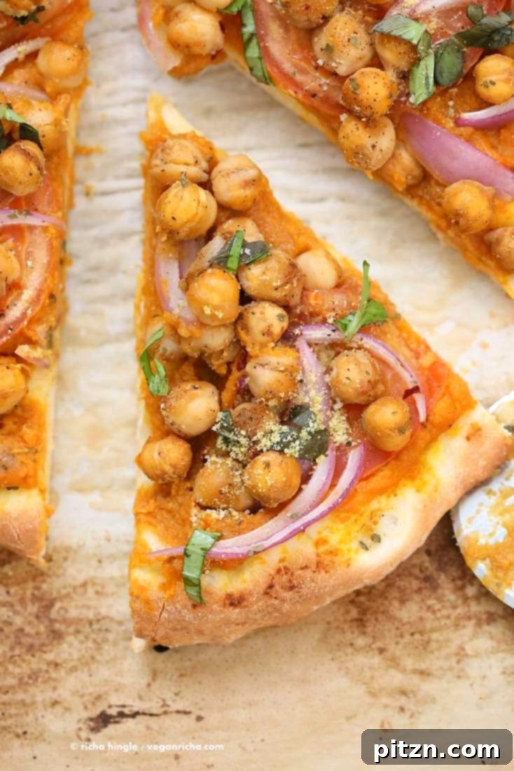 Golden Harvest Chickpea Pumpkin Pizza 4 Three generous slices of freshly baked Chickpea Pumpkin Veggie Pizza, garnished with vibrant fresh basil and vegan parmesan.