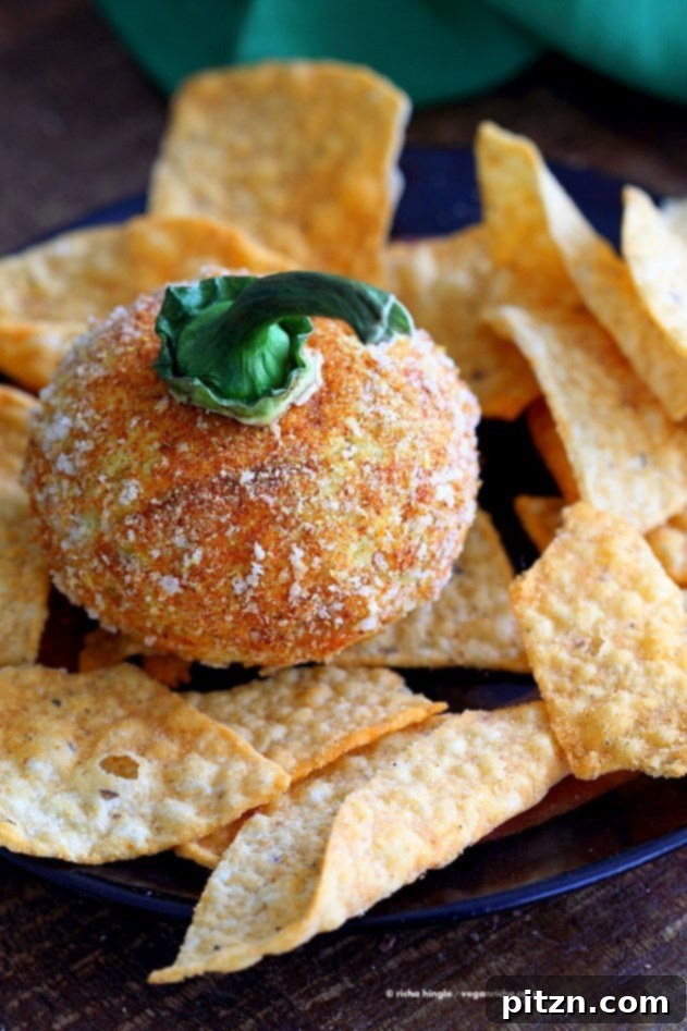 Close-up of a Nut-Free Vegan Cheddar Cheese Ball, showcasing its smooth texture and vibrant color. Ideal for Halloween, shaped like a pumpkin or served as a delightful dairy-free spread.