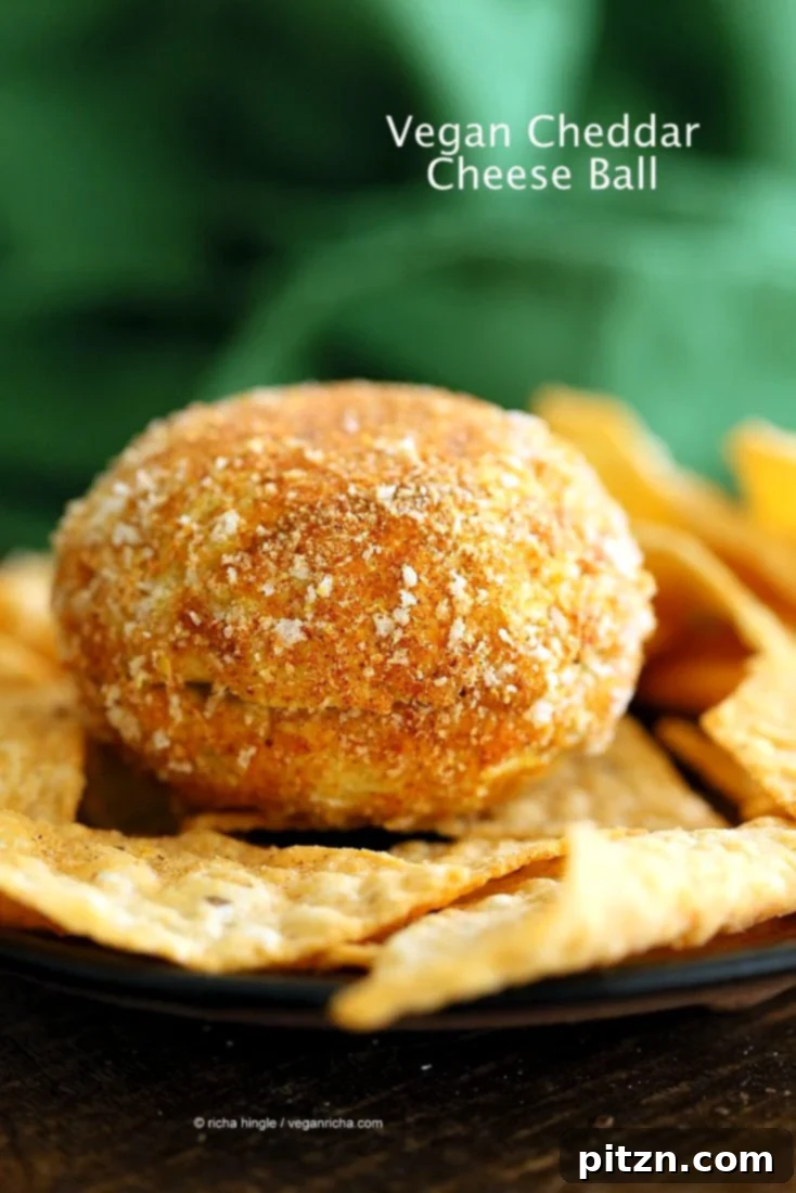 Finished Vegan Cheddar Cheese Ball, coated in a paprika and breadcrumb mixture, shaped for Halloween. A festive and healthy nut-free, dairy-free, gluten-free appetizer.