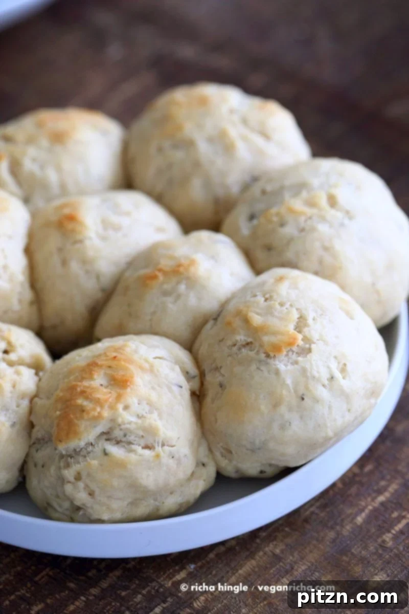 Freshly baked vegan dinner rolls, golden brown and ready to serve. Brushed with vegan butter for extra flavor.