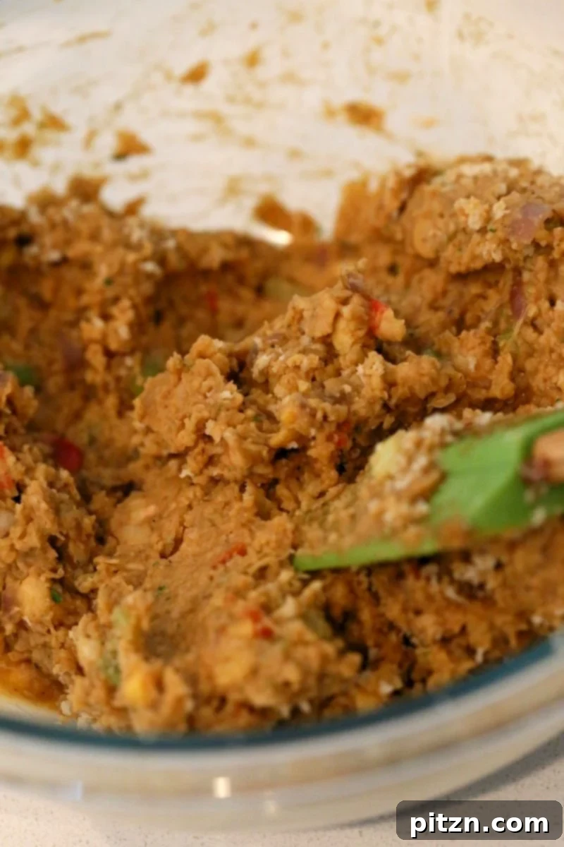 Delicious Plant-Based Chickpea Meatloaf 6 Preparing the Chickpea Veggie Loaf mixture: Cooked vegetables, pulsed chickpeas and beans, and spices ready to be combined for a flavorful vegan meatloaf.