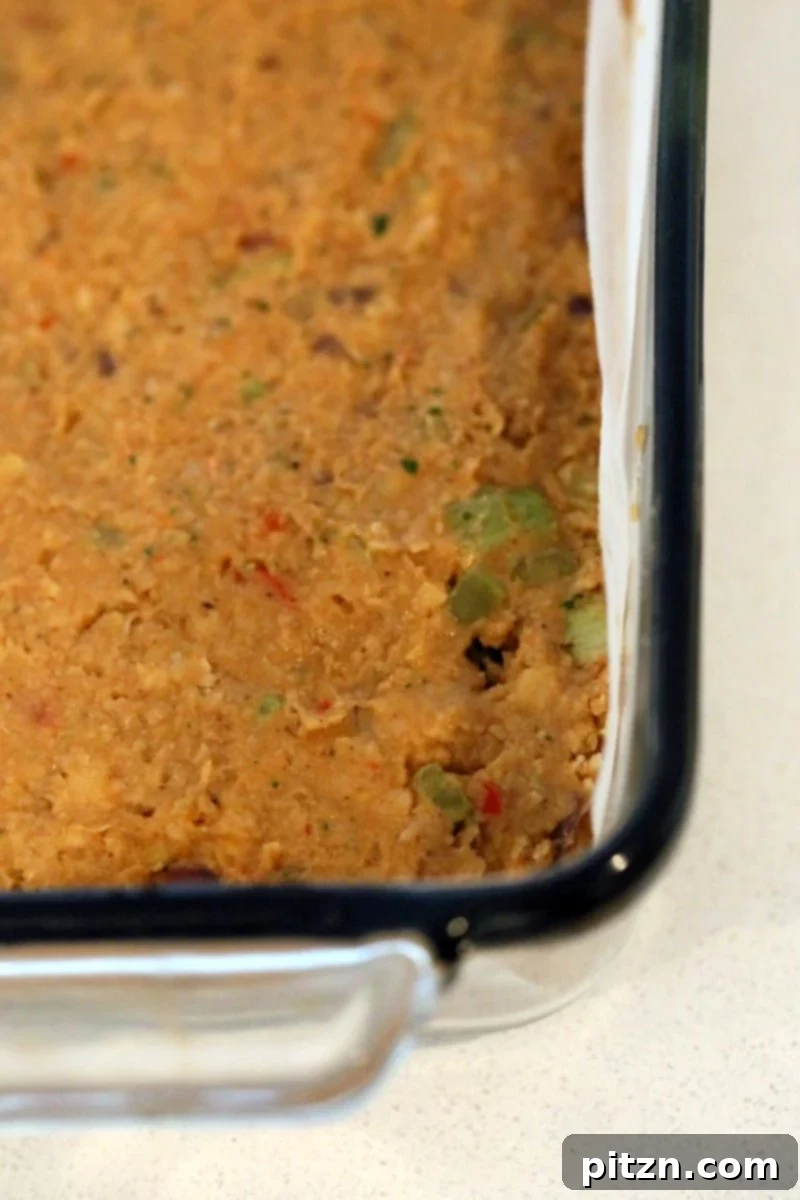 Delicious Plant-Based Chickpea Meatloaf 7 Shaping the Chickpea Veggie Loaf in a parchment-lined pan, ready for the spicy BBQ glaze and baking.
