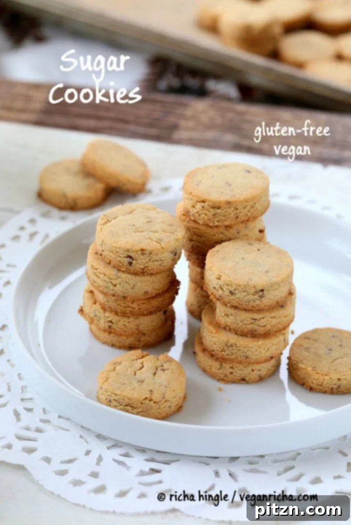 gluten-free vegan sugar cookies made with coconut flour stacked on a white cookie platter