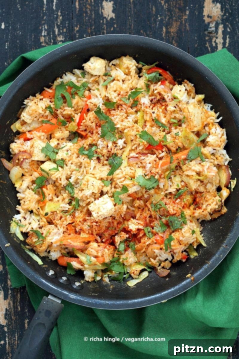 Savory Peanut Fried Rice 3 Colorful Vegan Peanut Sauce Fried Rice with Tofu, Carrots, Red Bell Pepper, Cabbage, and fresh Cilantro. A delightful gluten-free option.