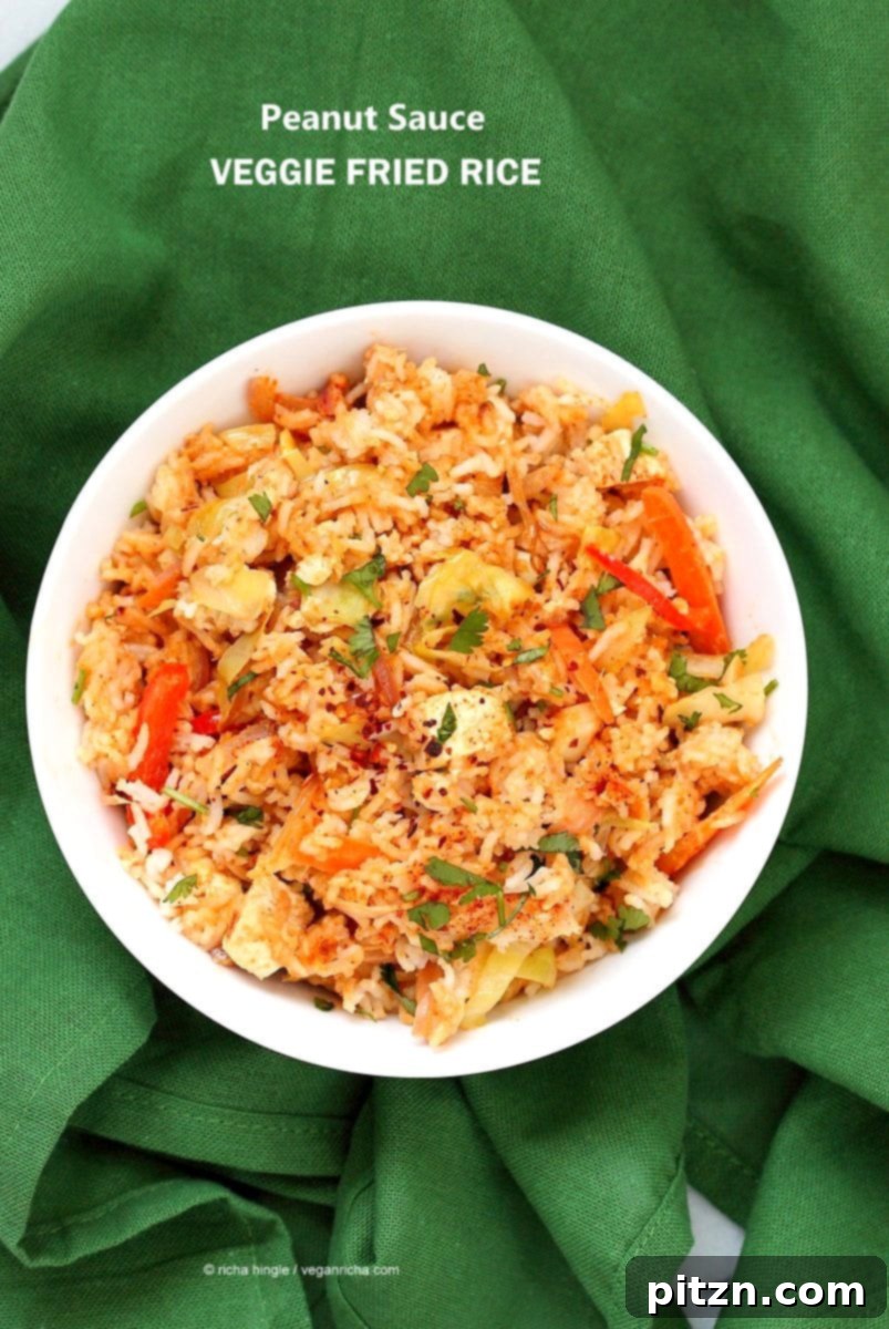 Savory Peanut Fried Rice 5 Close-up of a serving of Peanut Sauce Fried Rice, garnished with fresh cilantro and red pepper flakes, showcasing the rich colors and textures.