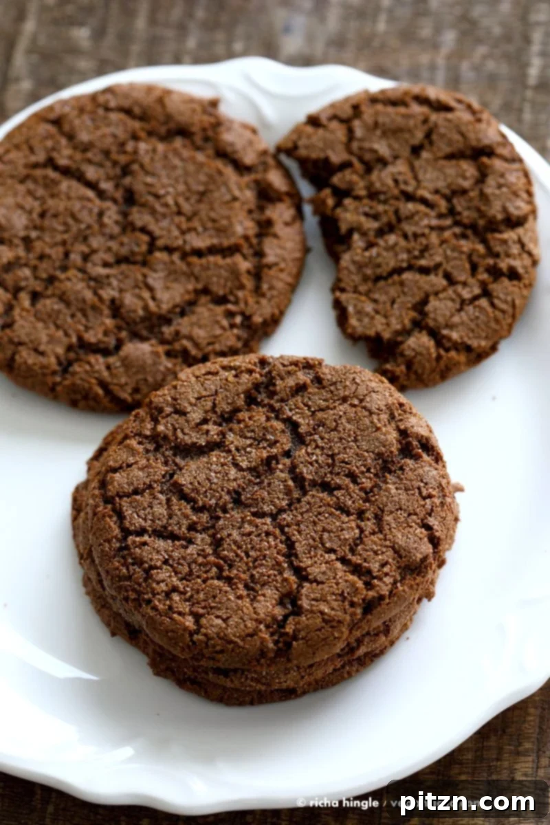 Beautifully crinkled giant vegan molasses cookie close up, showcasing its texture. Vegan Ginger molasses cookies. Huge, chewy and Crinkles! Easy #Holiday #Christmas #Cookie #Recipe.| VeganRicha.com