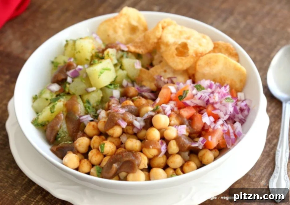 Zesty Chickpea Potato Chaat Bowl with Date Tamarind Drizzle 3 Another perspective of the Chickpea Aloo Chaat Bowl, emphasizing its fresh ingredients and vibrant colors. Featuring mint cilantro potatoes, spiced chickpeas, tamarind date chutney, onions, tomatoes, and chaat masala for a healthy, satisfying vegan meal. | VeganRicha.com #vegan #glutenfree #soyfree #nutfree #bowl #recipe