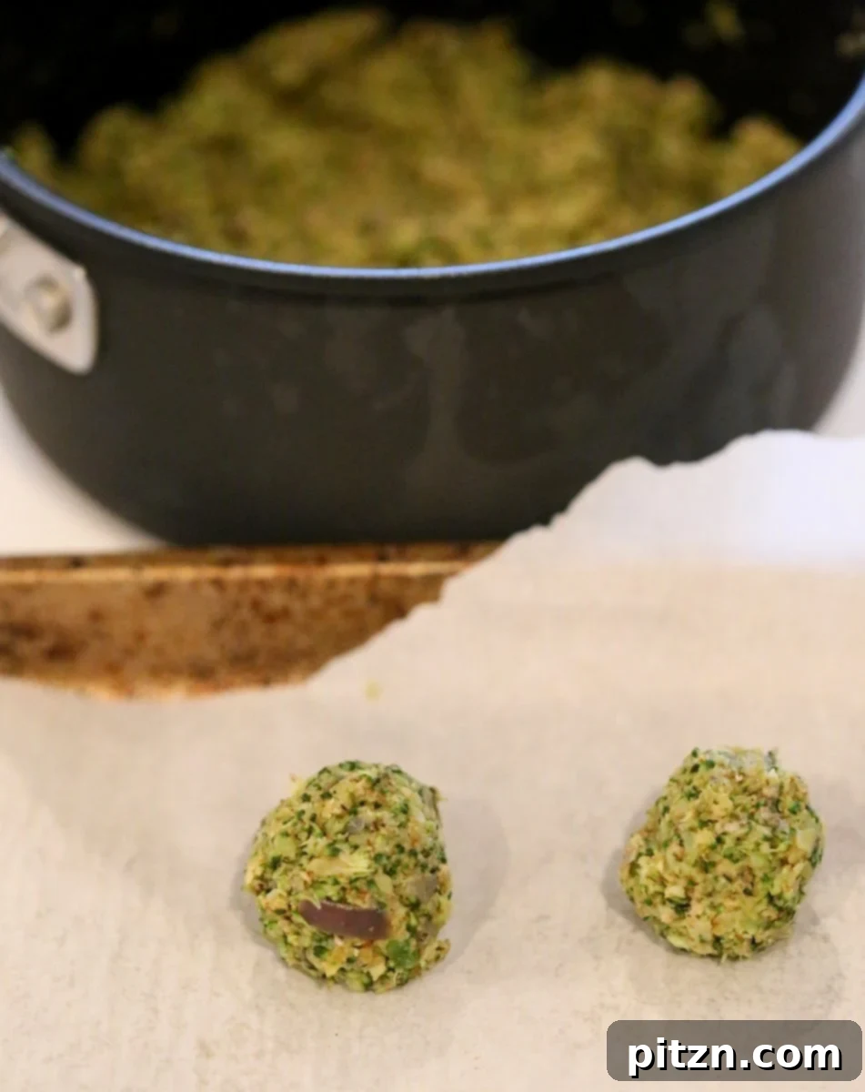 Unbaked Vegan Broccoli Balls, perfectly shaped and ready for the oven. These versatile veggie 'meatballs' are an easy vegan and gluten-free friendly recipe. #vegan #recipe #plantbased