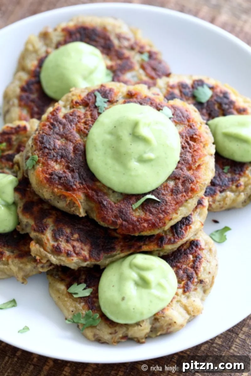 Boxty Irish Potato Cakes with Avocado Basil Ranch 4 Stack of freshly cooked Traditional Vegan Irish Boxty Potato Cakes, perfectly golden and crispy, garnished with fresh herbs and ready to be served with a side of creamy avocado basil ranch.