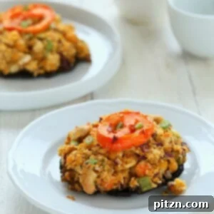 side view of vegan stuffed Portobello Mushrooms on a white plate
