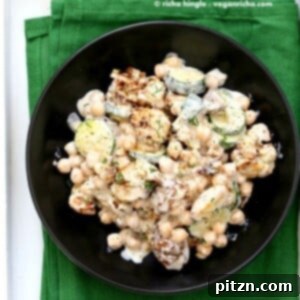 Vegan potato salad in a black bowl on a green kitchen towel