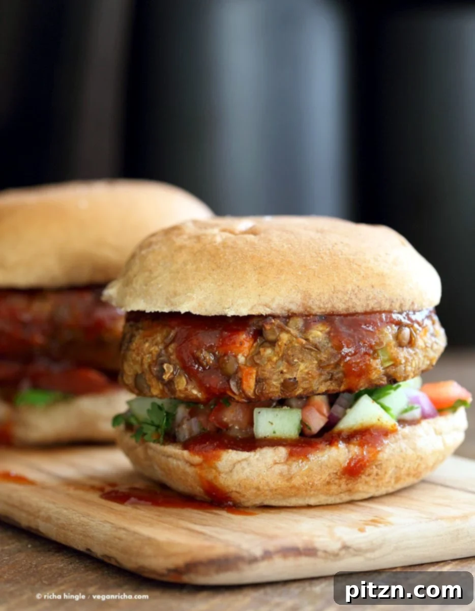 Homestyle Lentil Quinoa Burgers 7 Lentil Quinoa Meatloaf Burgers stacked high, with a dollop of spicy glaze, demonstrating their hearty and appetizing nature. A delicious vegan and nut-free meal option. VeganRicha.com