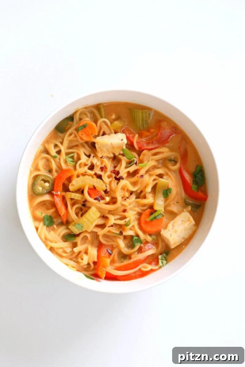 Making One Pot Peanut Sauce Noodles: Layer brown rice noodles, mixed vegetables, tofu, and a rich peanut sauce into a single pot for a super easy and fast vegan meal. | VeganRicha.com