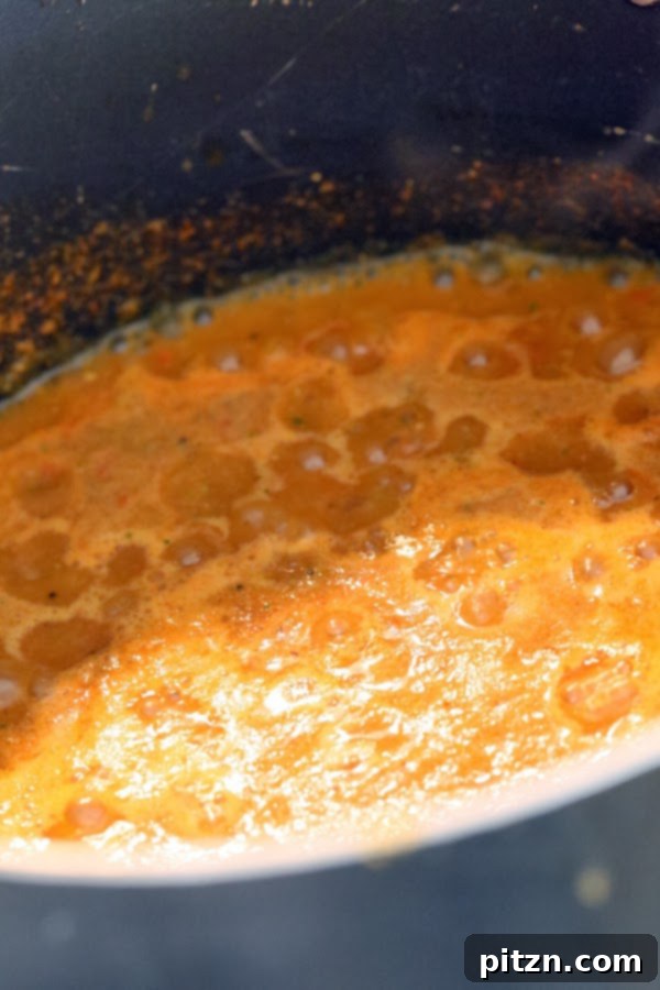 Spices roasting in oil before adding tomato mixture