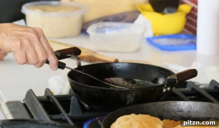 Mom frying Poori in a traditional Kadhai, dough puffing up