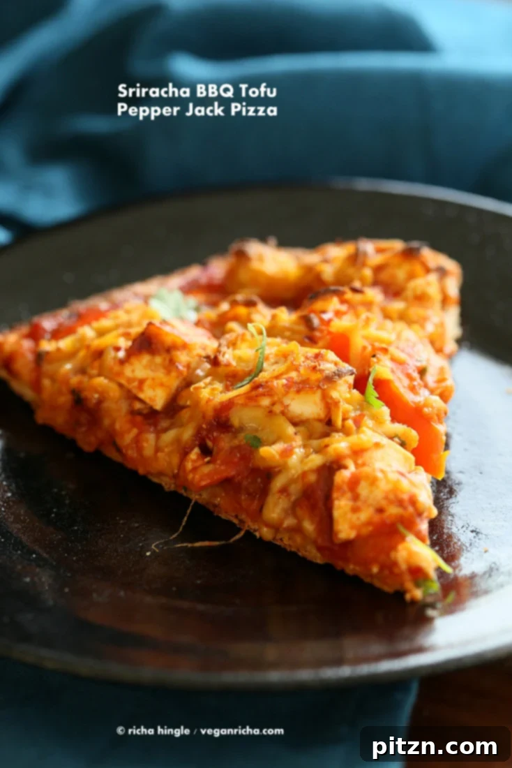 Fiery Vegan Sriracha BBQ Tofu Pizza with Zesty Pepper Jack on Spelt Crust 6 Freshly baked Vegan BBQ Tofu Pepper Jack Cheese Pizza garnished with cilantro, sliced and ready to serve.