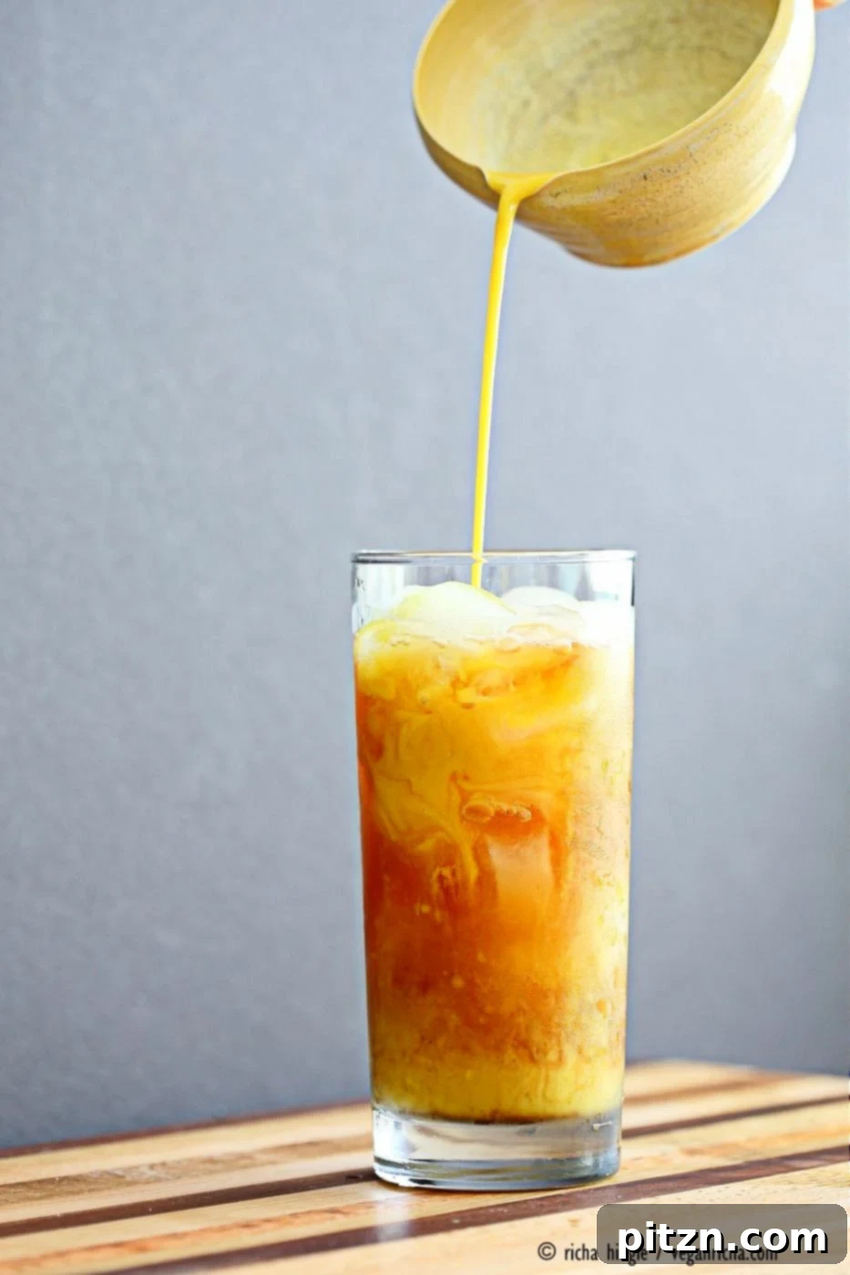 Cardamom Cinnamon Turmeric Iced Tea. Spiced Iced tea like Thai Iced tea with turmeric coconut milk and Indian masala chai spices and ginger. Golden Milk Iced Tea. Vegan Gluten-free Soy-free Recipe | VeganRicha.com