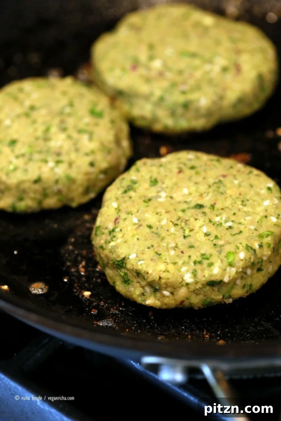 Flavorful Vegan Falafel Burgers Made Easy 5 Easy Vegan Falafel Burger. Perfectly cooked chickpea patties with a generous spread of tahini sauce, nestled between fresh vegetables and a toasted bun.