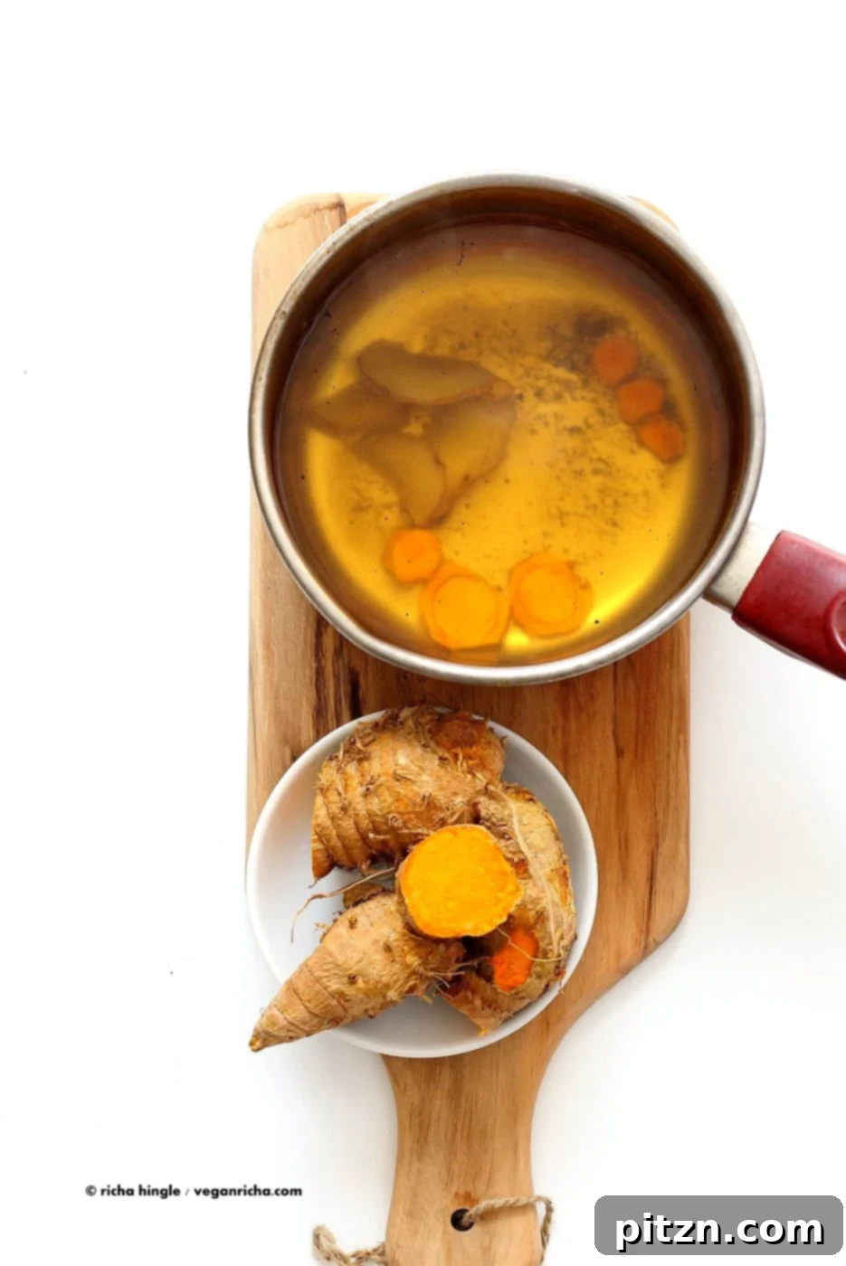 Golden Ginger Wellness Brew 3 Close-up of Ginger Turmeric Root Tea. Fresh turmeric and ginger simmered with black pepper, ready to be sweetened and enjoyed hot or chilled. A delicious vegan and gluten-free recipe.