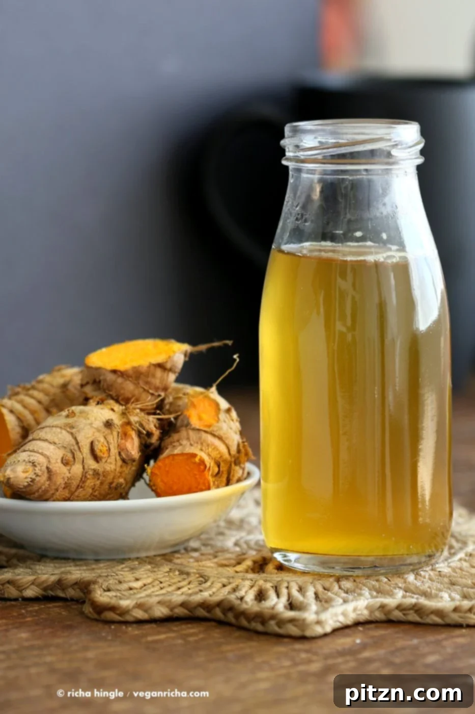 Golden Ginger Wellness Brew 4 Finished glass of Ginger Turmeric Root Tea. A vibrant golden tonic with fresh ingredients, perfect for a soothing hot drink or a cooling iced tea. Vegan, gluten-free, and full of flavor.