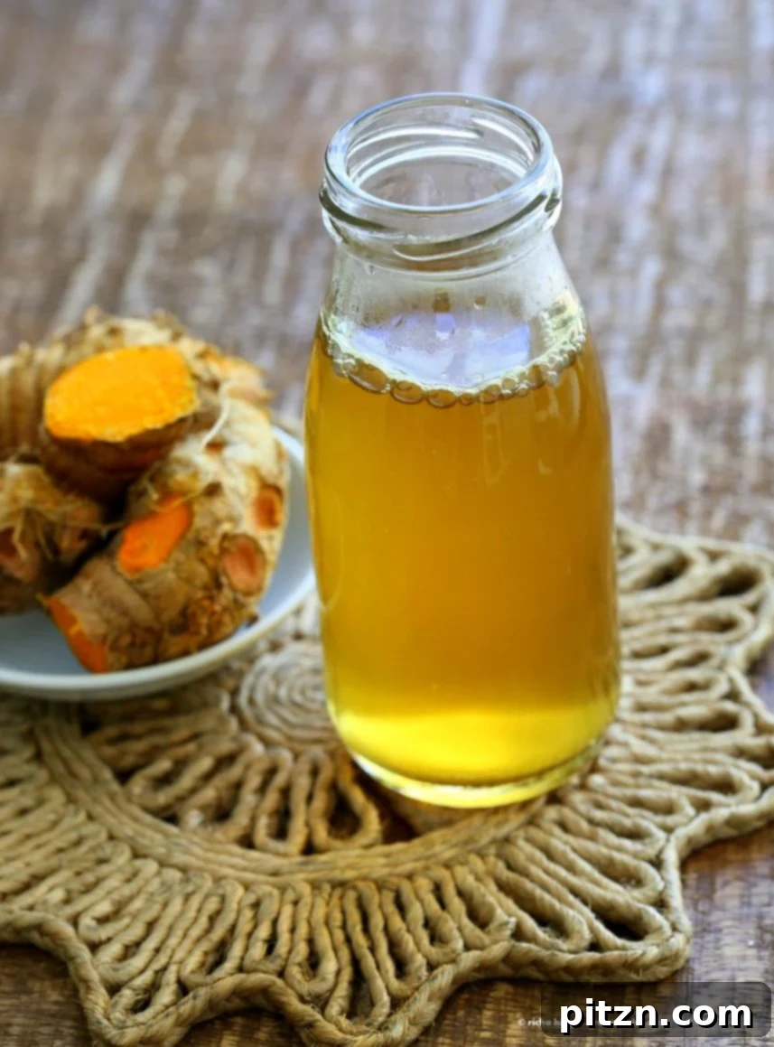 Golden Ginger Wellness Brew 6 Top-down view of Ginger Turmeric Root Tea in a mug, garnished with lemon slices. A warm, inviting, vegan, and gluten-free beverage for health and comfort.