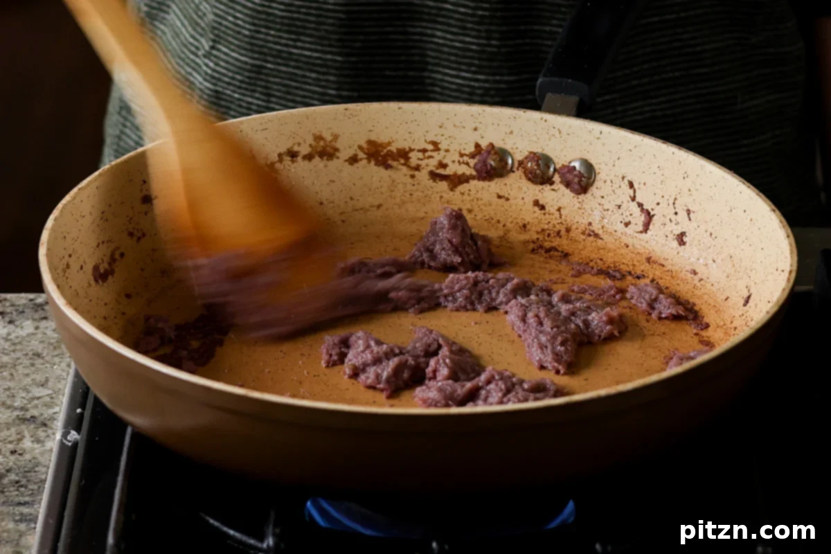 The aromatic mixture in the skillet, beautifully cooked down and slightly browned after several minutes of sautéing, indicating deep flavor development.