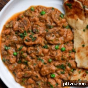 bowl of mushroom matar masala with flatbread