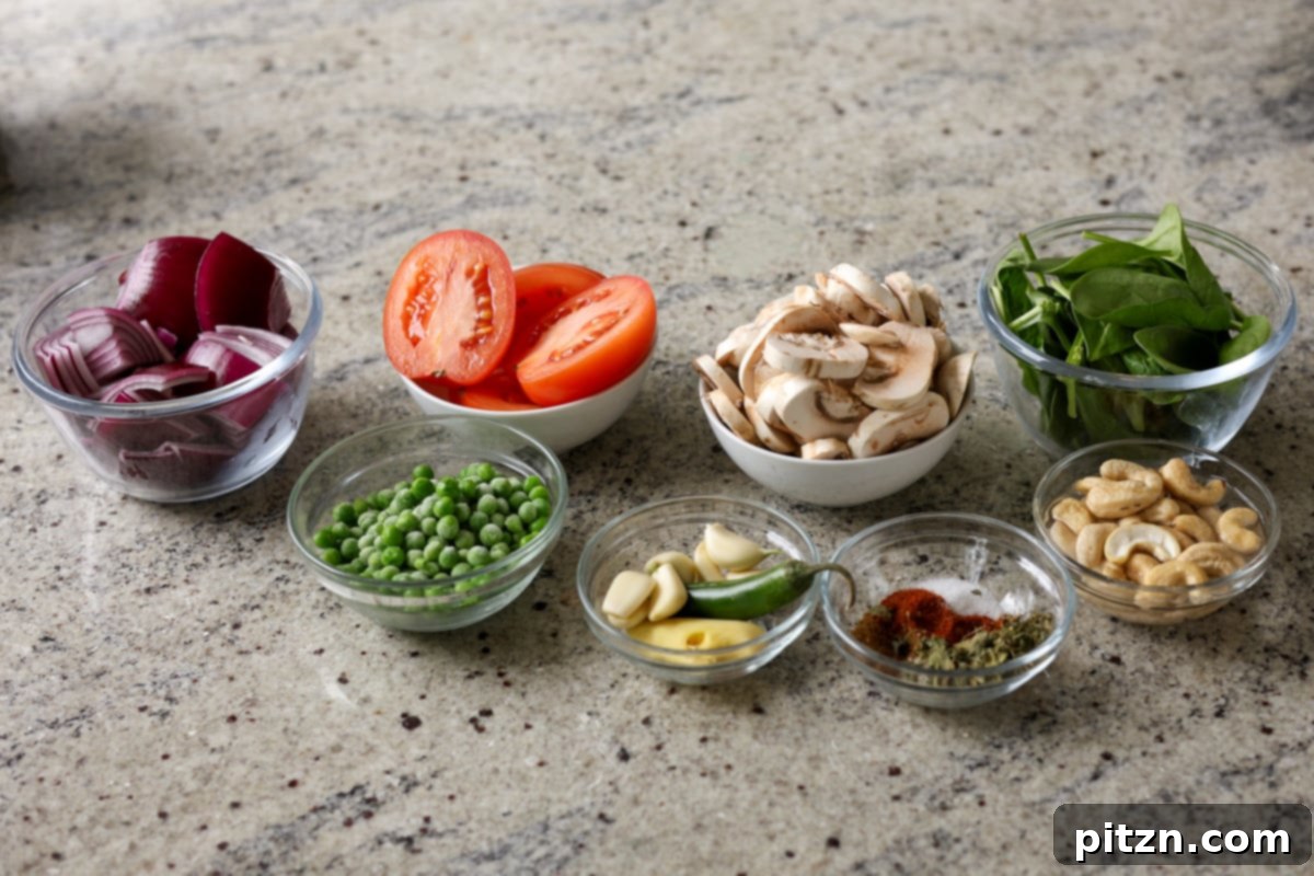 A selection of fresh ingredients for Matar Masala, including mushrooms, peas, tomatoes, onions, and spices, laid out beautifully on a kitchen counter.