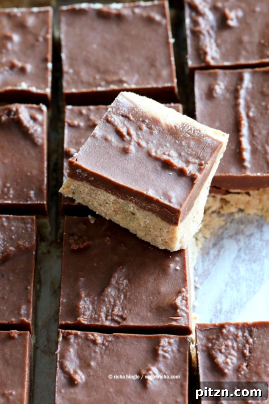 Decadent Chocolate Almond Butter Fudge Bars 4 A batch of freshly made Chocolate Almond Butter Fudge Bars, stacked on a cooling rack. This easy, vegan, gluten-free, and soy-free recipe uses almond butter or peanut butter for a delicious no-bake fudge.