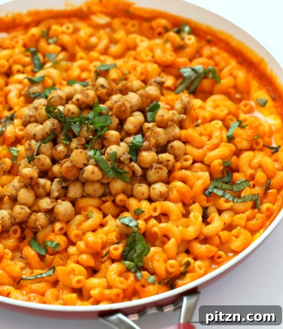 Creamy Roasted Red Pepper Pasta with a Kick of Black Pepper Chickpeas 3 A vibrant overhead shot of Creamy Roasted Red Pepper Pasta with Black Pepper Chickpeas, highlighting the rich red sauce, tender pasta, and golden crispy chickpeas, garnished with fresh basil.