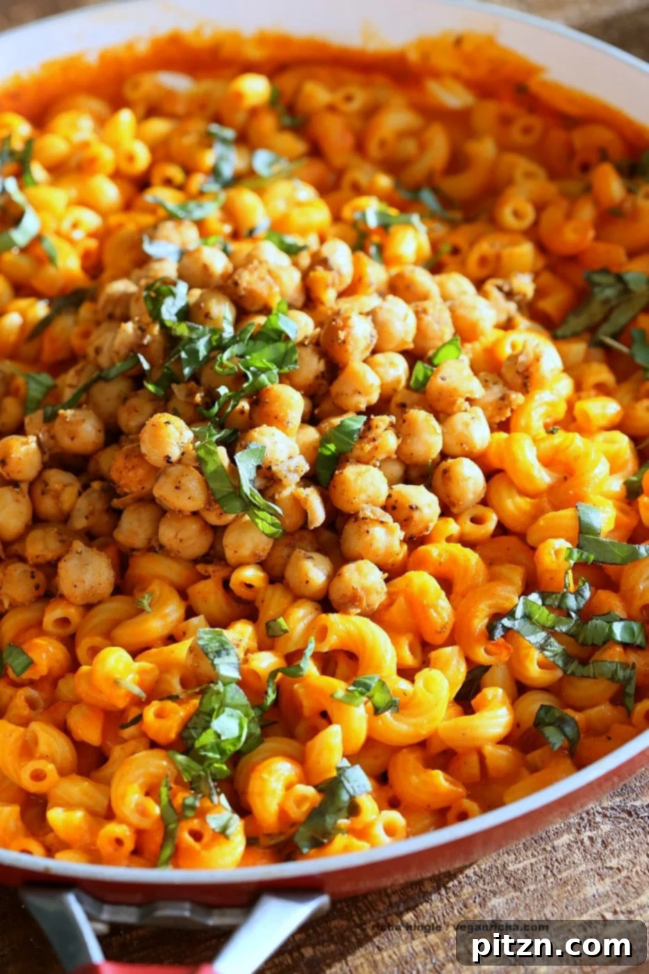 Creamy Roasted Red Pepper Pasta with a Kick of Black Pepper Chickpeas 4 Another beautiful shot of the creamy roasted red pepper pasta, showcasing the vibrant red color of the sauce and the textures of the pasta and chickpeas.