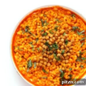Creamy Roasted Red Pepper Pasta, garnished with crispy chickpeas and fresh basil.