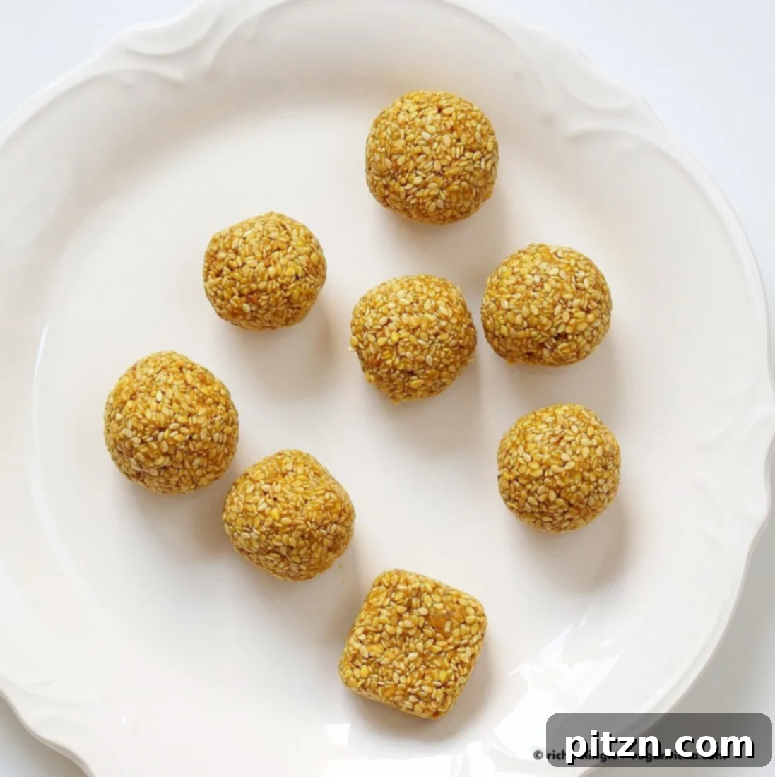Crispy Golden Sesame Balls 6 A close-up of a beautifully textured Golden Turmeric Sesame Ball, showcasing the vibrant golden hue and the specks of sesame seeds, cinnamon, and cardamom. Vegan, gluten-free, nut-free and healthy.