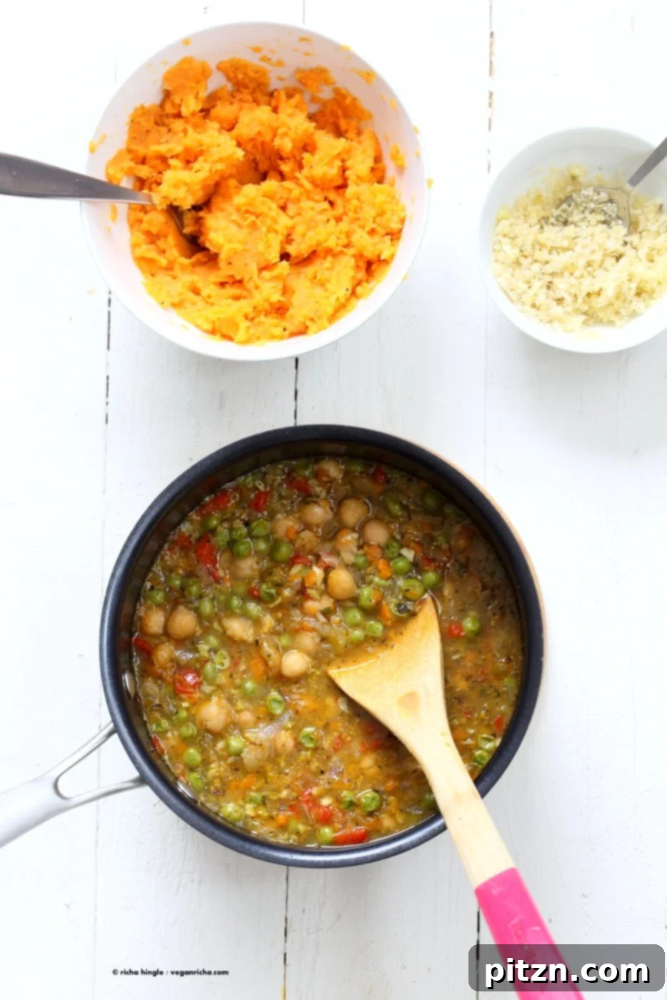 Hearty Vegan Chickpea and Sweet Potato Shepherd's Pie 3 Vegan Shepherd's Pie layers revealed: a close-up of the rich chickpea and veggie filling beneath the creamy sweet potato mash, ready for baking.