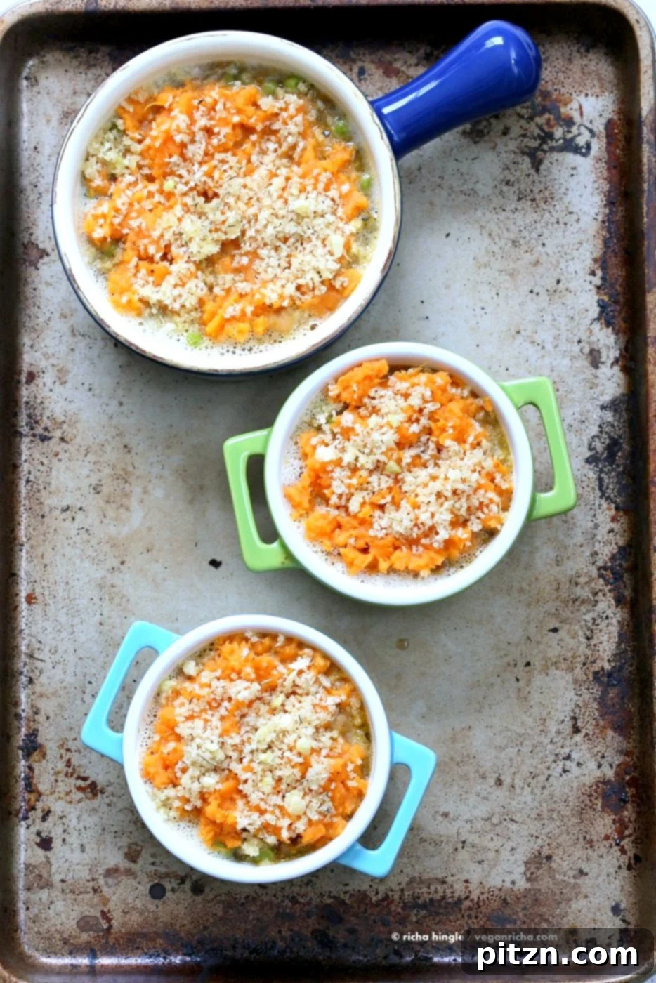 Hearty Vegan Chickpea and Sweet Potato Shepherd's Pie 4 Finished Vegan Shepherd's Pie with Chickpeas and Sweet Potato, golden brown and garnished with fresh herbs, ready to be served.