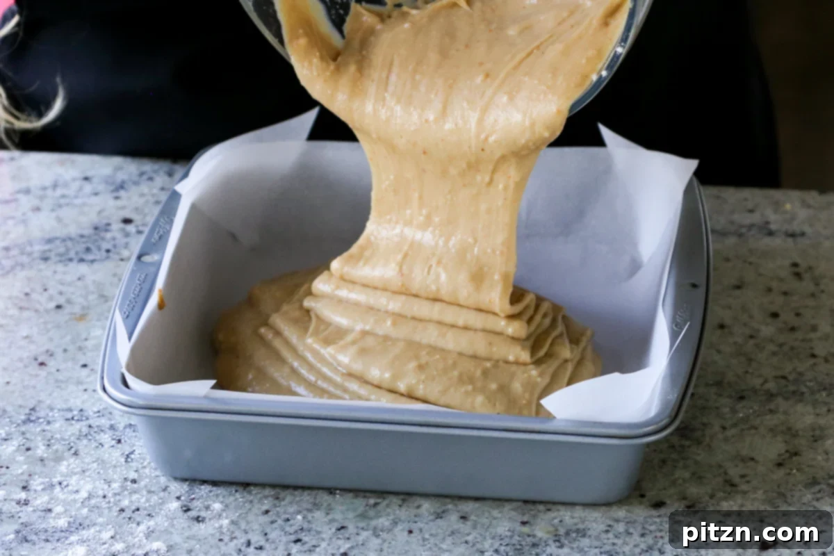 Vegan Double Peanut Butter Chocolate Cake 12 Pouring vegan peanut butter cake batter into the prepared pan