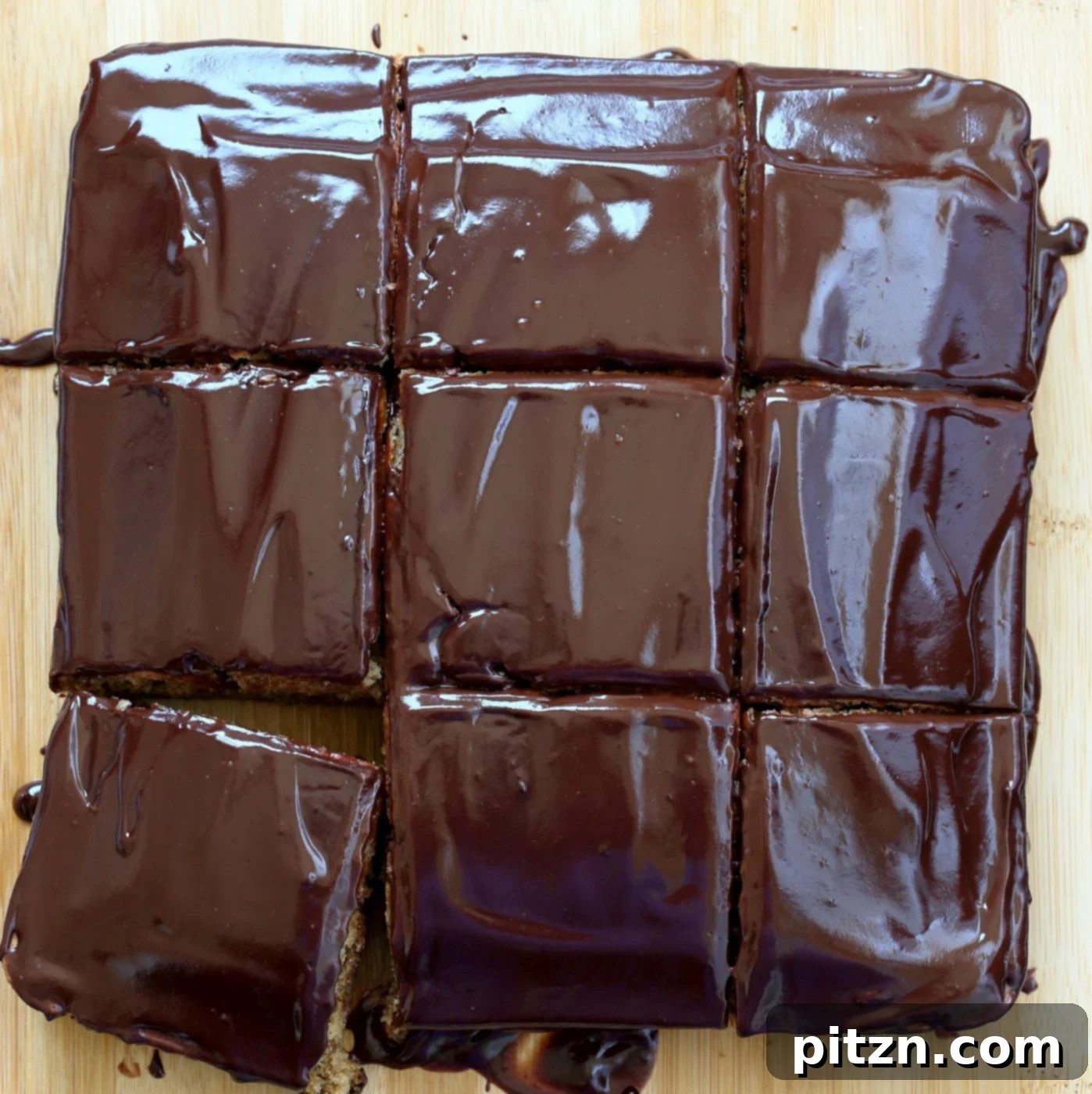 Vegan Double Peanut Butter Chocolate Cake 3 Overhead photo of chocolate glaze being spread on the vegan peanut butter cake