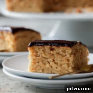 slice of peanut butter cake with chocolate peanut butter glaze