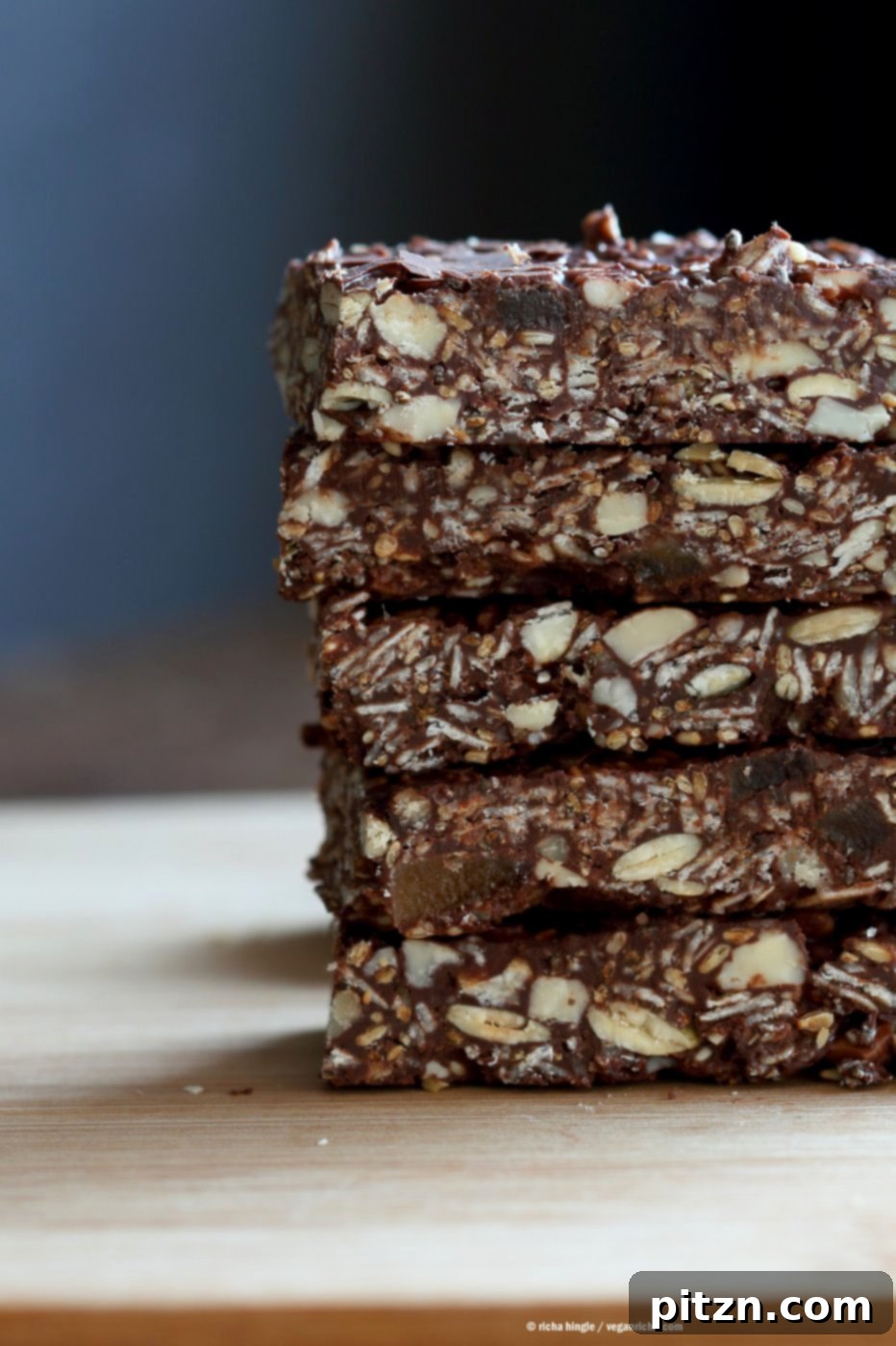 Seeded Ginger Chocolate No Bake Granola Bars 7 A perfectly chilled and sliced Super Seedy Chocolate No Bake Granola Bar, ready to serve. This image emphasizes the delicious and convenient nature of these easy, healthy, vegan, gluten-free, and nut-free snack bars with candied ginger and gingerbread spices, suitable for any occasion.