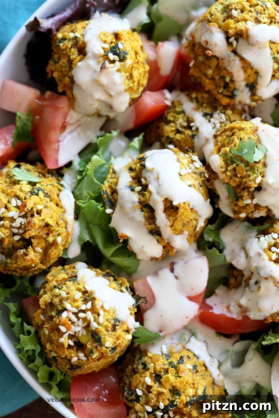 Turmeric Lentil Fritters Tomato Greens Bowl with Tahini Dill Sauce. Baked Seedy Golden Lentil fritters with greens, tomatoes and a tahini sauce make an easy Lunch bowl. #Vegan #Nutfree #Soyfree #Recipe. Easily #Glutenfree #veganricha | VeganRicha.com