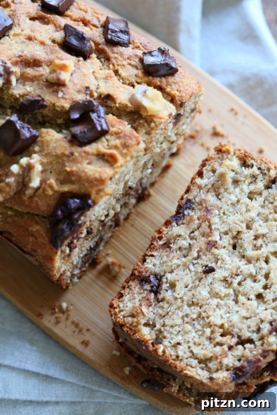 Delicious slice of Vegan Banana Bread with Walnuts and Coconut, perfect for breakfast or a sweet treat. 