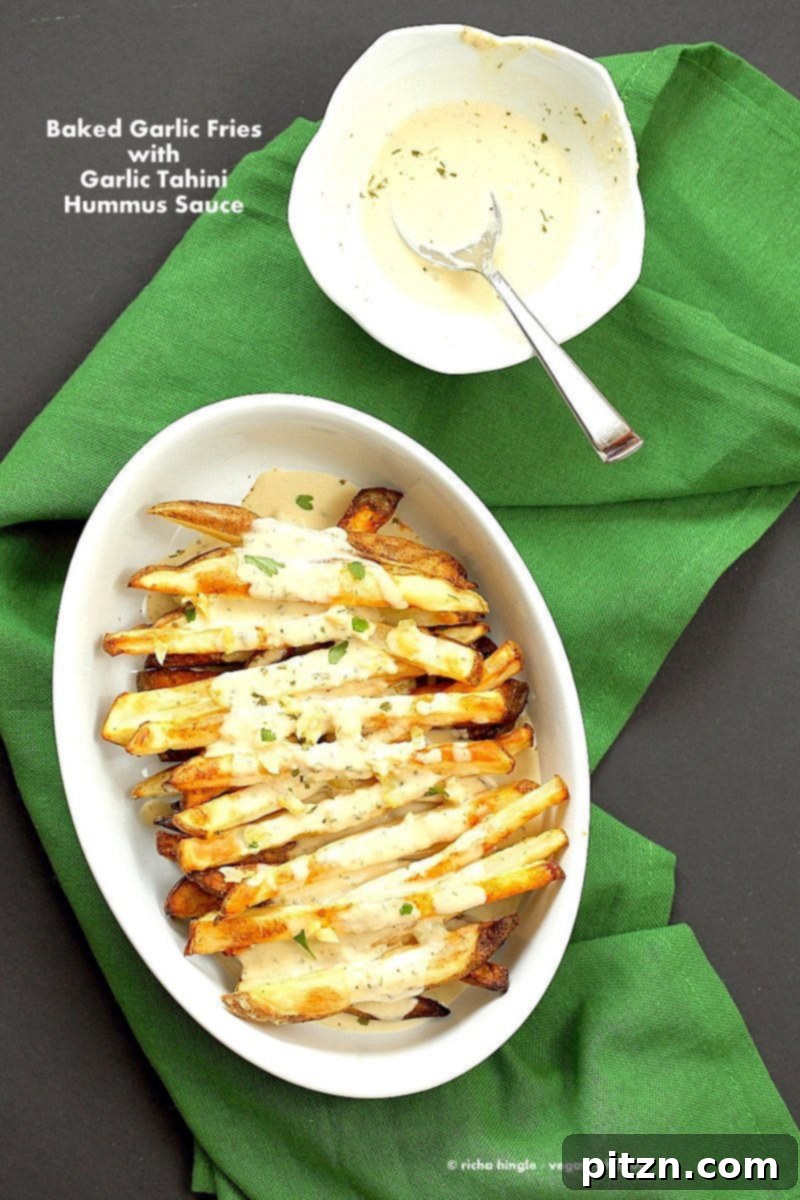 Baked Fries with Garlic Sauce: Russet potato fries baked and covered in a creamy tahini hummus lemon sauce. A delicious vegan, gluten-free, and soy-free appetizer from VeganRicha.com.