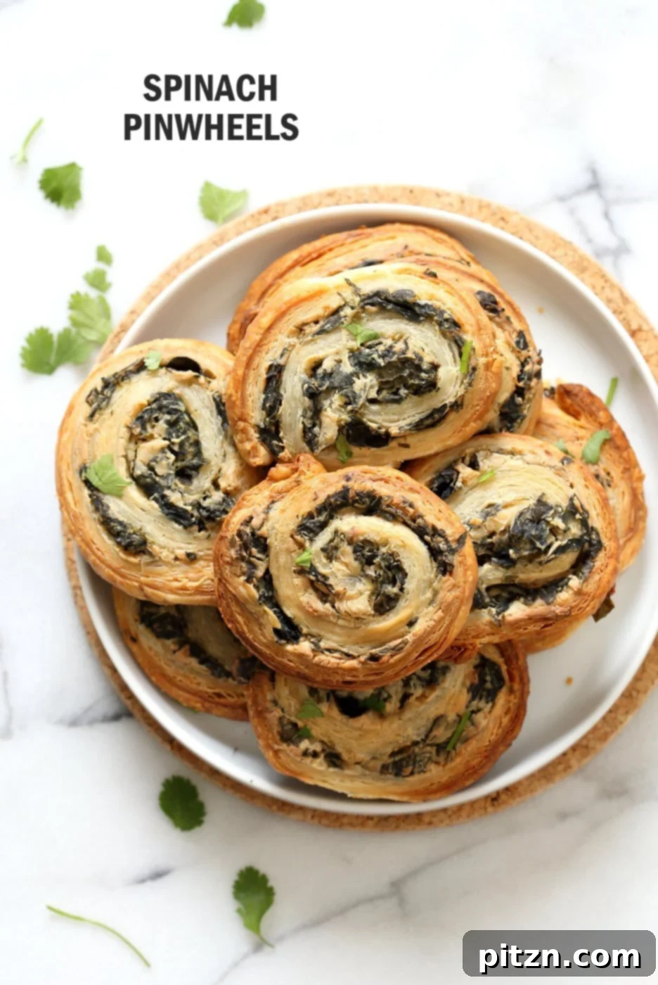 Vegan Spinach Pinwheels: Creamy, cheesy spinach dip spread on puff pastry, rolled, sliced, and baked for a perfect snack. Vegan and soy-free recipe by VeganRicha.com.